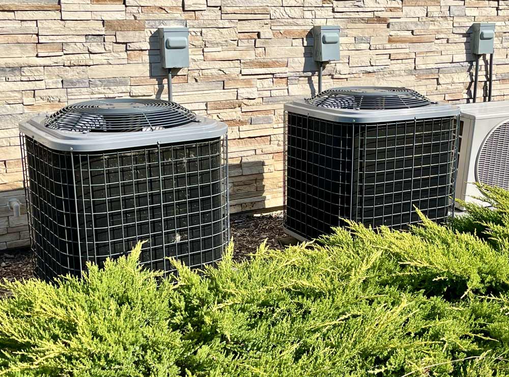 Two air conditioning units attached to a home
