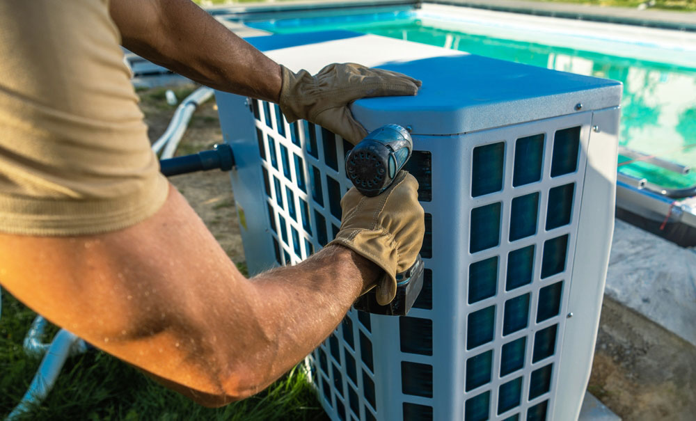 Hvac,technician,installing,pool,heater,near,swimming,pool
